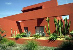 a red building with cactus in front of it