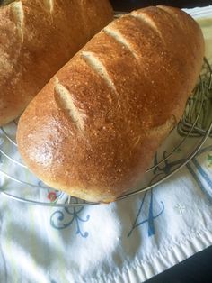 two loaves of bread sitting on top of a glass plate with the words polish sauerkraut bread