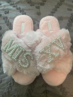 two pairs of pink slippers with the word mr and mrs on them