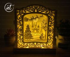 an illuminated christmas scene in the shape of a frame