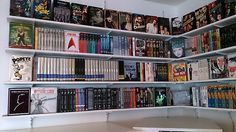 a bookshelf filled with lots of different types of books on top of white shelves