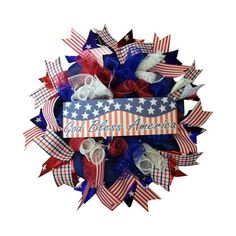 a patriotic wreath with red, white and blue ribbons