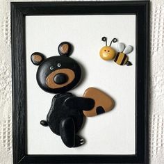 a black bear and a yellow bee are in a frame