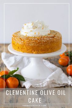 a close up of a cake on a plate with whipped cream and oranges in the background