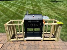 an outdoor bbq grill made out of pallets and wooden crates on a brick patio