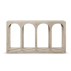 a white wooden shelf with four arches on the top and bottom, in front of a white background