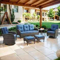 an outdoor patio with blue cushions and furniture