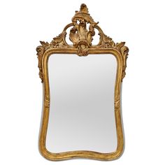 an ornate gold framed mirror against a white background