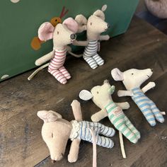 several stuffed animals sitting on top of a wooden table