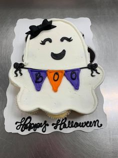 a decorated halloween cupcake sitting on top of a white plate