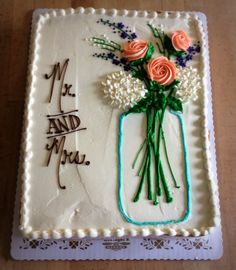 a cake decorated with flowers and the words mr and mrs written in frosting on it