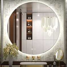 a bathroom with a large round mirror above the sink and gold fixtures on the wall