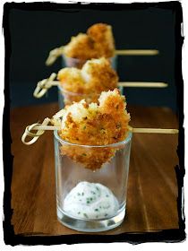 two small cups filled with food on top of a wooden table