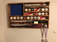 a baseball bat and medal hanger on the wall in a room with white walls