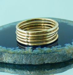 This Polished Gold stacking ring set is entirely hand-made & mixes well with most of the items in our store. * This listing is for one 5-band set. * Made with: 16g (1.29 mm) 12k Yellow Gold-filled wire. * When stacked, bands measure at about 7 rings per half inch. * We do make 1/2 & 1/4 sizes, just leave a note with your size preference. * All of our items are entirely hand crafted and have a standard processing time of 3-5 Business days to make the order. * It will be placed in the care 5 Golden Rings, Golden Rings, Stack Ring, Stacking Ring Set, Golden Ring, Thumb Ring, Gold Ring Stack, Midi Rings, Thumb Rings