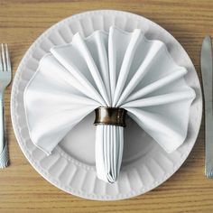 a white plate topped with a napkin and silverware