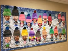 a bulletin board with hats on it in a school hallway at the end of winter