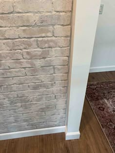 a white brick wall in the corner of a room