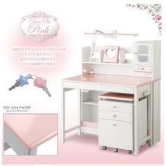 a pink desk with drawers and keys on it