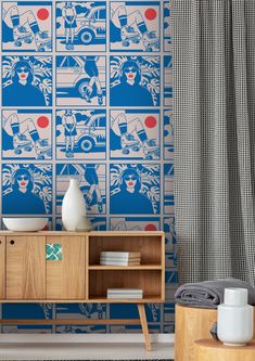 a blue and white wallpaper in a living room with a wooden cabinet next to it