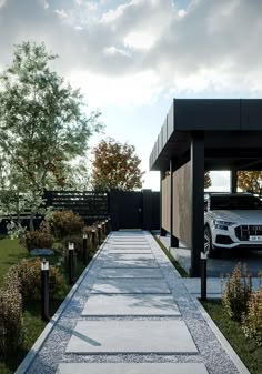 a white car is parked in front of a house with black fence and landscaping around it