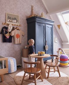 a small child sitting at a table in a room