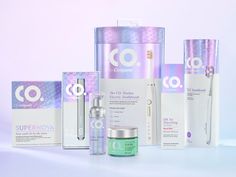 an assortment of skin care products displayed in front of a white background with purple and blue accents