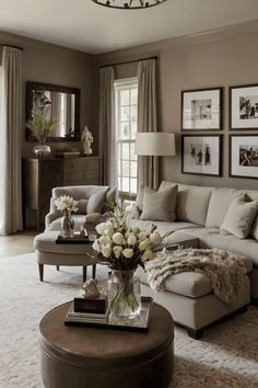 a living room filled with lots of furniture and pictures on the wall above it's coffee table