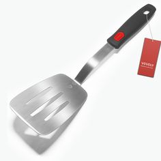 a stainless steel spatula with a red tag hanging from it's side on a white background