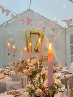 the table is set with candles, plates and napkins for an elegant wedding reception