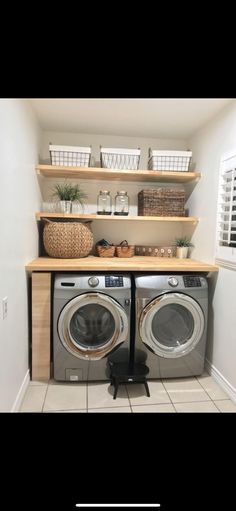 a washer and dryer in a small room with shelves above the washer