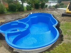 an above ground swimming pool in the middle of a yard with grass and dirt around it