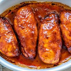 baked chicken wings in barbecue sauce in a white casserole dish