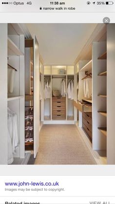 a walk in closet with white walls and drawers