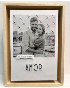 a wooden frame with an image of a couple holding each other and the word's name