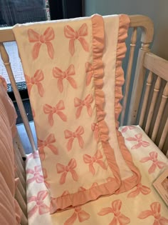 a baby crib with pink bows on it