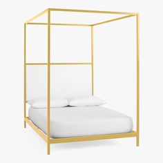 a white bed with a gold frame and pillows on it's sides, against a white background