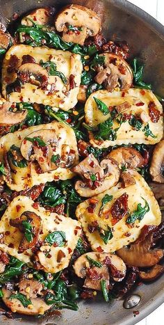 a pan filled with chicken and spinach covered in sauce