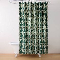 a shower curtain with green leaves on it