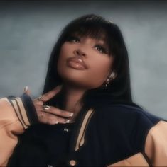 a woman with long black hair and piercings on her fingers is posing for the camera