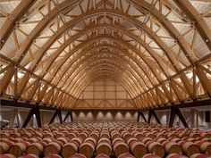 a large room filled with lots of barrels in front of a vaulted ceiling and wooden walls