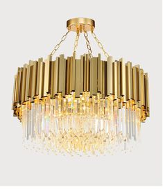 a large chandelier with many lights hanging from it's sides and gold fixtures