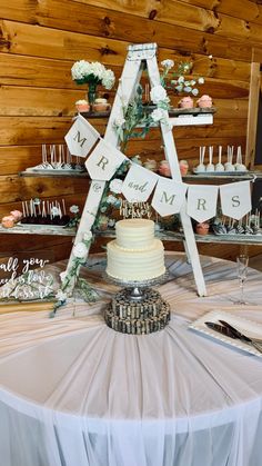 a table topped with a cake and lots of cupcakes on top of it