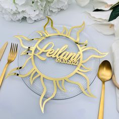 there is a plate with the word hello sunshine on it next to silverware and flowers