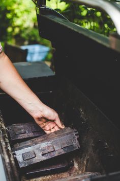 a person reaching for something in the back of a truck