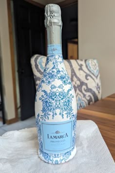 a blue and white bottle sitting on top of a table