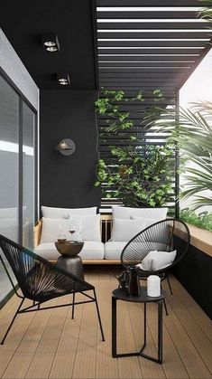 an outdoor living area with black and white furniture