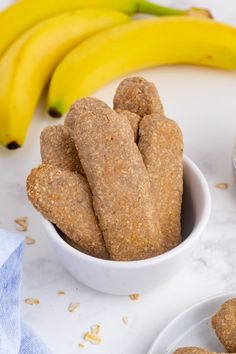 some bananas are sitting on the table next to some cookies