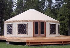 a yurt sitting on top of a wooden platform