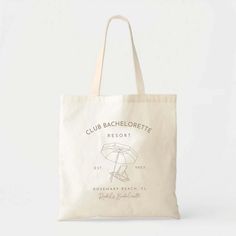 a white tote bag with the club bachelore logo on it